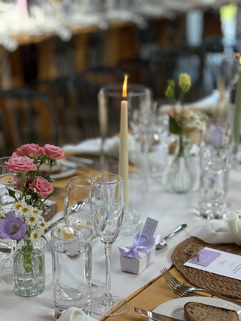 Close-up of rustic place setting with floral centrepiece